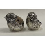 A good quality silver pin cushion in the form of a chick together with one other.