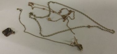 A small collection of 9 carat chains together with a gilt pendant.