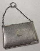 SAMPSON MORDAN: An engine turned silver travelling card case. London 1919.