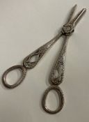 A Victorian silver plated pair of grape scissors with feather edge.