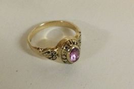 A 10 carat gold ladies college ring with amethyst mount.