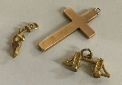 A group of three gold charms.