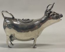 A silver cow creamer. Import marked and marked to base and on lid