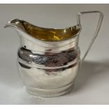 A George III bright-cut silver jug. London 1803. By William Bennett.
