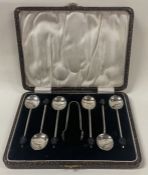 A set of six cased silver coffee bean spoons and tongs. Birmingham 1933. By SLD.