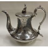 A very fine engraved silver chinoiserie teapot. Birmingham 1841.