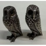 A pair of heavy silver owl peppers.