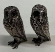 A pair of heavy silver owl peppers.