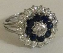 A large circular sapphire and diamond cluster ring.