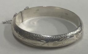 An engraved silver bangle.