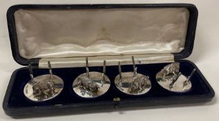 A set of four silver menu holders with warthog figures. London 1909. By Carrington & Co.