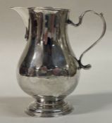A George III silver pitcher jug. London 1735. By George Greenhill Jones.
