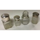 A group of four silver mounted scent bottles.