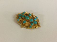 A heavy 15 carat gold Victorian brooch set with turquoise stones.