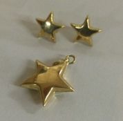 A pair of 18 carat gold star shaped earrings together with matching pendant.