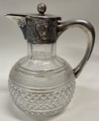 An Edwardian chased silver and glass claret jug. Birmingham 1908.