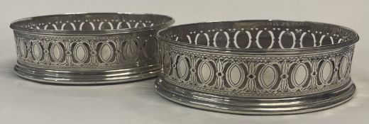 A fine pair of 18th Century George III pierced silver wine coasters. London 1789. By Robert Hennell.