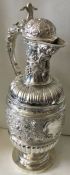 EDINBURGH: A very fine chased silver wine jug heavily embossed with flowers and vines. 1876.