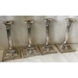 A fine set of four Edwardian silver candlesticks with swag decoration. Sheffield 1904.