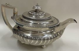 A good Georgian silver teapot of half fluted design. London. By WB.