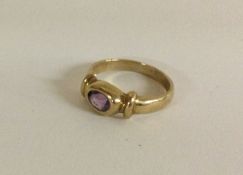 A 9 carat single stone ring in oval setting.