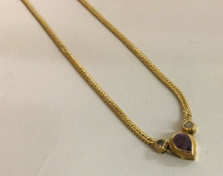 An 18 carat gold diamond and amethyst necklace.