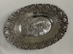 A chased German silver basket embossed with cherub and dogs.