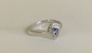 A tanzanite and diamond tear shaped cluster ring.