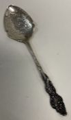 A silver preserve spoon with chased handle. Birmingham.