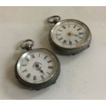 Two silver fob watches.