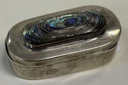 A silver hinged box set with a stone.