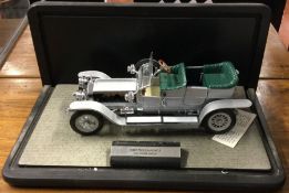 A cased 1:16 scale model car of a 1907 Rolls-Royce Silver Ghost.