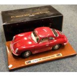 BBURAGO: A 1:18 scale boxed model car of a Porsche 356B Coupé on wooden plinth.