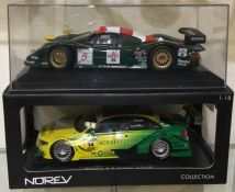 A 1:18 scale boxed model of an Audi A4 together with a 1:18 scale cased model of a Porsche.