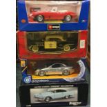 Four boxed 1:18 scale model cars.