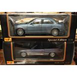 MAISTO: Two 1:18 scale boxed model cars.