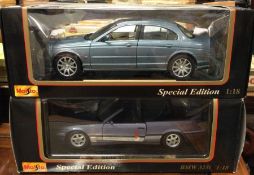 MAISTO: Two 1:18 scale boxed model cars.