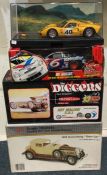 A collection of four various boxed model cars.