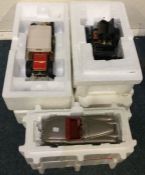 A collection of three boxed model cars.