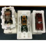 Three various 1:24 scale boxed model cars.