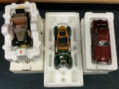 Three various 1:24 scale boxed model cars.