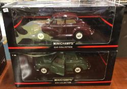 MINICHAMPS: Two 1:18 scale boxed Morris Minor model cars.