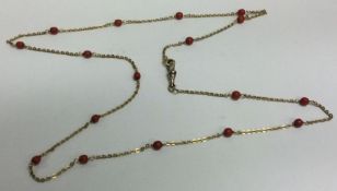 A good coral and 18 carat gold half guard chain with ring clasp.