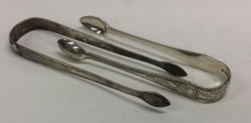 A pair of Georgian silver bright-cut sugar tongs together with one other similar pair.