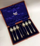 A good boxed set of six silver teaspoons together with matching tongs. Sheffield.