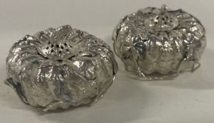 A pair of unusual Japanese silver peppers in the form of pumpkins.