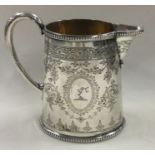 An engraved Victorian silver jug. London 1871. By Alexander Macrae.