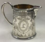 An engraved Victorian silver jug. London 1871. By Alexander Macrae.