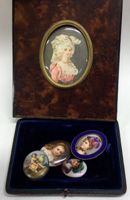 A group of four oval porcelain miniatures etc. Est. £20 - £30.