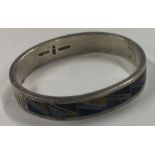 A heavy quality silver and stone bangle. Approx. 59 grams